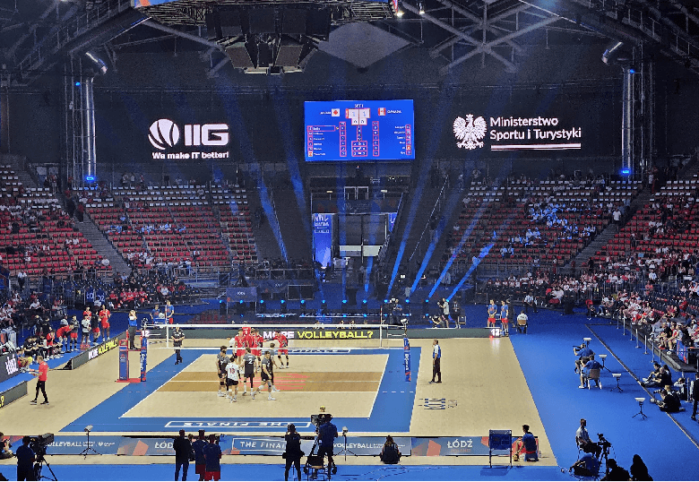 Volleyball court with IIG logo visible on telebims 