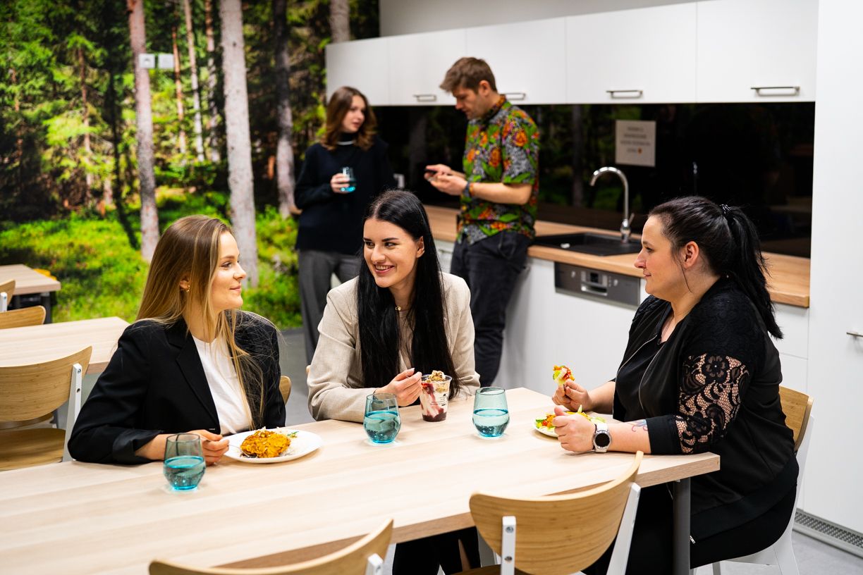 A group of people eating lunch in the company kitchen