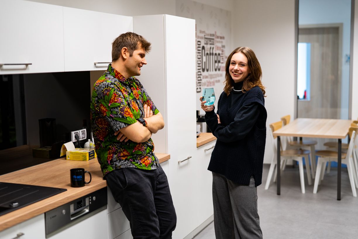 Employees in the kitchen drink coffee